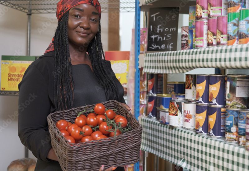 Black woman volunteer in food pantry